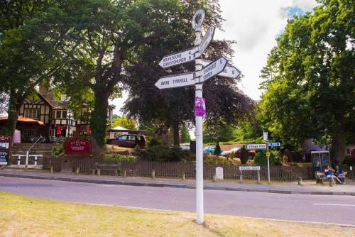 a pole with street signs on the side of a road at The Burley Inn in Burley