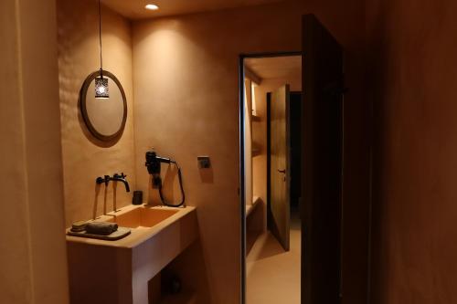 a bathroom with a sink and a mirror at Life Gallery Hotel & Spa in Korçë