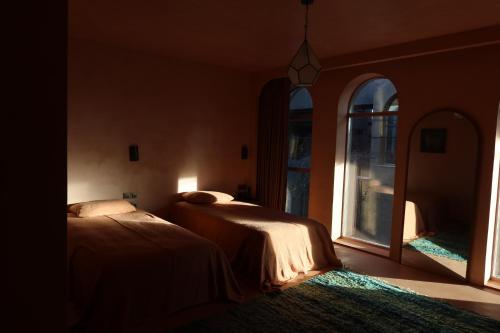 two beds in a room with a window at Life Gallery Hotel & Spa in Korçë