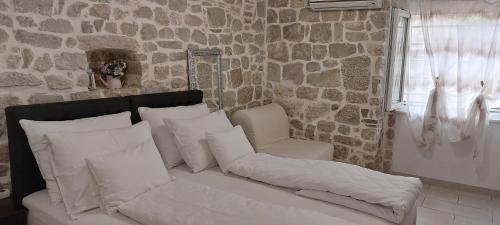 a white couch with pillows and a chair in a room at Antea in Split