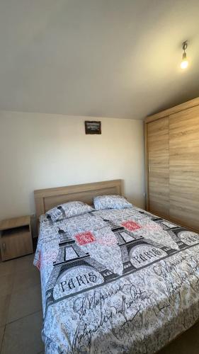 a bedroom with a bed with a quilt on it at Sea in Ulcinj
