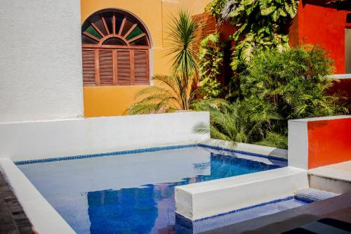 a house with a pool in front of a building at Hotel Boutique Casa Don Gustavo, Campeche in Campeche