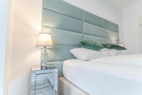 a bedroom with a bed with a headboard and a lamp at Luxury Vienna 6BR Villa with Private Pool & Sauna - Pets allowed in Vienna