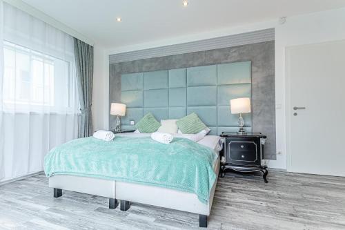 a bedroom with a large bed with a blue headboard at Luxury Vienna 6BR Villa with Private Pool & Sauna - Pets allowed in Vienna