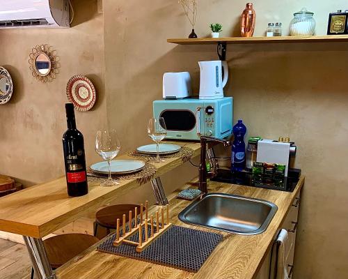 a kitchen with a counter with a sink and a microwave at Boutique apartment in heart of Haifa in Haifa