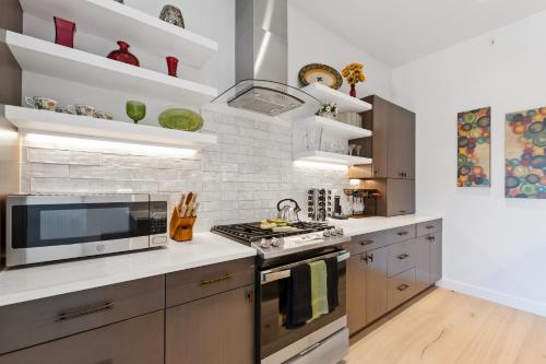 a kitchen with a stove and a microwave at Alpenglow Retreat in Whitefish