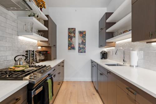 a kitchen with a stove top oven next to a sink at Alpenglow Retreat in Whitefish