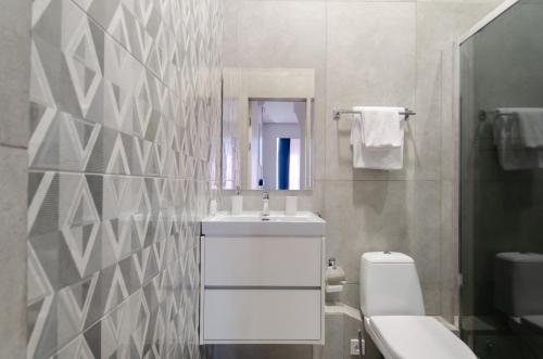 a bathroom with a sink and a toilet and a mirror at Smart App near Railway Station Kvartet 3C in Kyiv