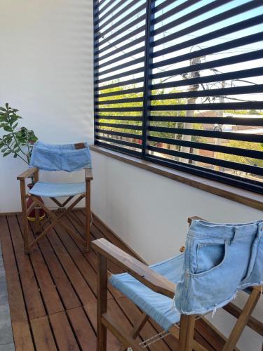 two chairs and a table in a room with a window at Departamento Del Este in Trinidad