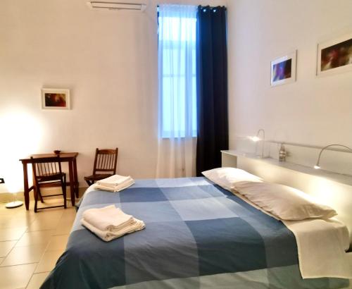 a bedroom with a bed with towels on it at castle apartment in Bari