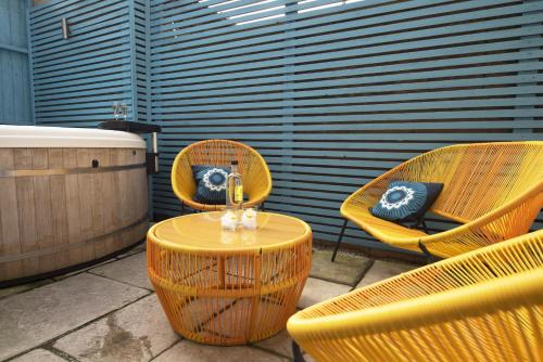 a patio with three chairs and a table at Harington's Boutique Hotel in Bath