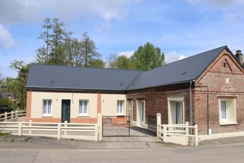 a brick house with a black roof at Au Clair matin sur l'Yères in Sept-Meules
