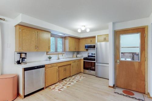 a kitchen with wooden cabinets and a white refrigerator at Gridiron Getaway-Where Families and Fans Unite in Canton