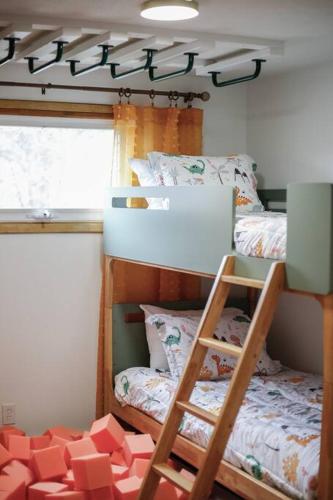 a room with two bunk beds and a ladder at Gridiron Getaway-Where Families and Fans Unite in Canton