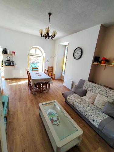 un salon avec un canapé et une table dans l'établissement Le 6 Magnifique appt Bagnères-de-Bigorre 3étoiles, à Bagnères-de-Bigorre