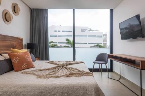 a bedroom with a desk and a bed and a deskablish at Downtown modern apartment Unique location in Playa del Carmen