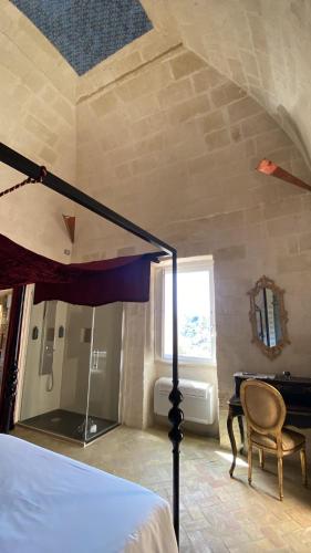 a bedroom with a bed and a table and a mirror at Maison d'Ax in Matera