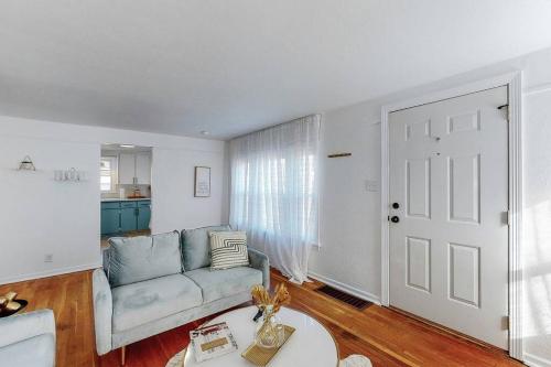 a living room with a couch and a table at End Zone Escape-Light and Bright HOF Village Home in Canton