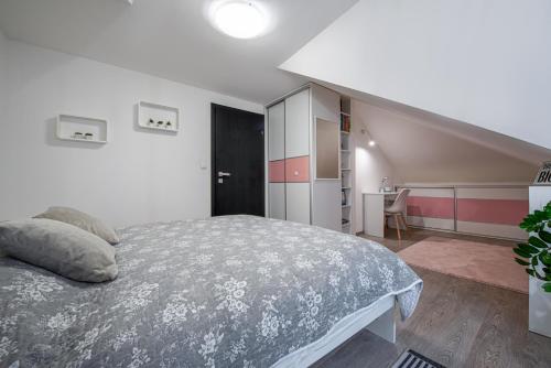 a bedroom with a large bed and a staircase at Chillgarden Apartments in Trenčín