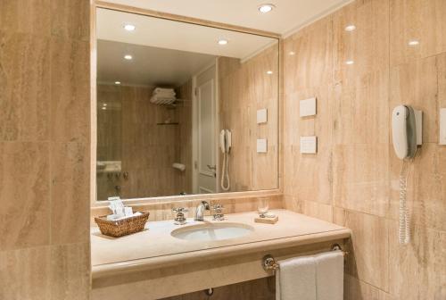 a bathroom with a sink and a mirror at Loi Suites Recoleta Hotel in Buenos Aires