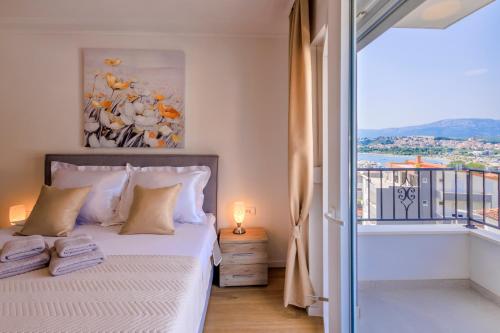 a bedroom with a bed and a window with a view at Apartment Maya in Podstrana