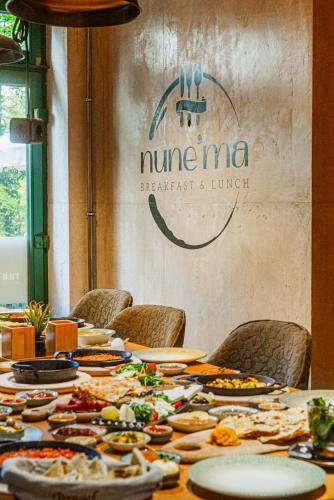 a long table with plates of food on it at Hotel CityHome am Kurpark in Bad Salzuflen