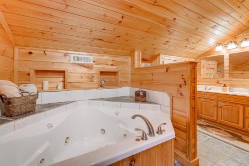 baño con bañera en una cabaña de madera en Smoky Mountain Log Cabin Close to Rafting!, en Hartford
