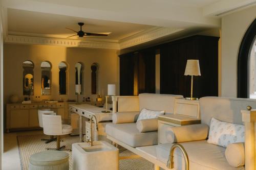 a living room with a couch and a table at Cap Juluca, A Belmond Hotel, Anguilla in West End Village