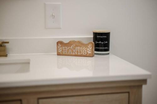 a counter top with a bottle and a sign on it at The Perfect Pass-HOF Village Escape in Canton
