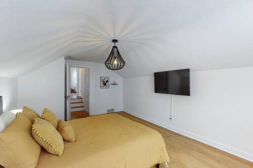 a bedroom with a bed and a flat screen tv at The Perfect Pass-HOF Village Escape in Canton