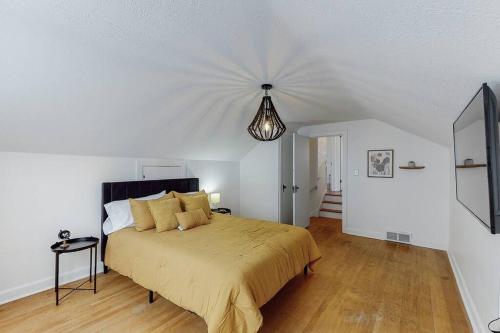a bedroom with a large bed and a chandelier at The Perfect Pass-HOF Village Escape in Canton