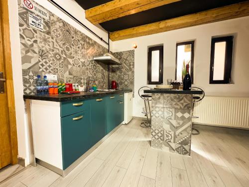 a kitchen with blue cabinets and a counter top at Venus Central Lux Studio in Craiova