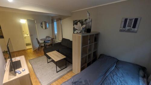 un soggiorno con letto, divano e tavolo di Sjarmerende og sentral hybel med egen Inngang a Oslo