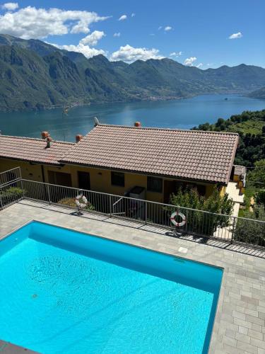 a house with a swimming pool and a view of a lake at Lake Lodge in Fonteno