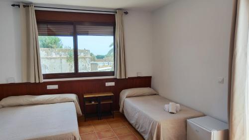 Posteľ alebo postele v izbe v ubytovaní Hostal Jadraza