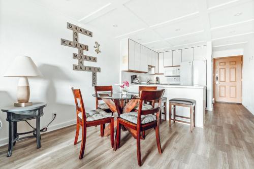 a kitchen and dining room with a table and chairs at Banyan Harbor Resort in Lihue
