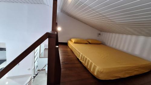 Bett in einem kleinen Zimmer mit einer Decke in der Unterkunft LocaGuyane in Matoury