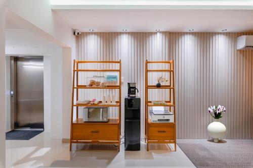 a room with wooden shelves and a vase with flowers at Coralia Boutique Hotel Cozumel in Cozumel