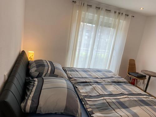 a bedroom with two beds in front of a window at Ferienwohnung Lina in Kronau