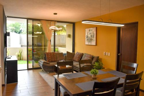 Infinity Pool Apartment في سان سلفادور: غرفة معيشة مع طاولة وأريكة