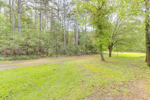 a dirt road in the middle of a field with trees at Tumbling Shoals Cabin Less Than 1 Mi to Beaches and Boating! in Heber Springs