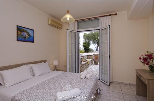 a bedroom with a bed and a sliding glass door at Blue Horizon in Gaios