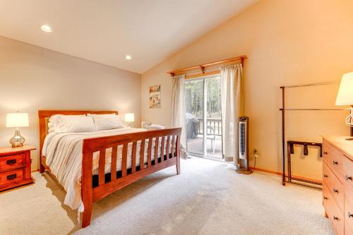 a bedroom with a bed and a large window at Home with Deck and Access to Tahoe Donner Amenities! in Truckee