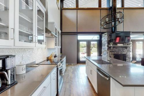 a kitchen with white cabinets and a counter top at Some Kind of Wonderful-Escape Near Seneca Lake in Senecaville