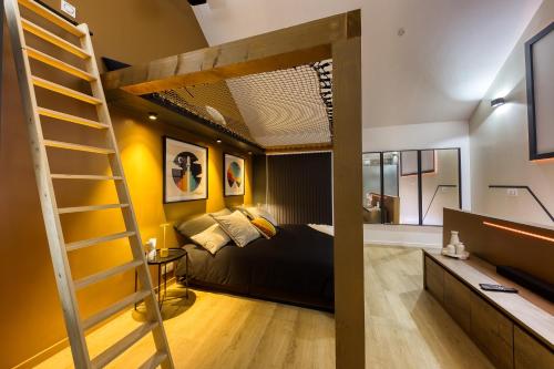 a bedroom with a bunk bed and a ladder at Relax House & SPA - DISNEY in Crecy la Chapelle