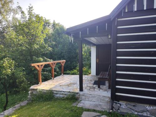 a porch of a house with a bench next to it at horská chata Cecilie in Olešnice v Orlických horách