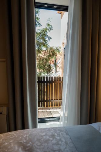 a bedroom window with a view of a balcony at GRAND CENTRAL LJUTOMER in Ljutomer