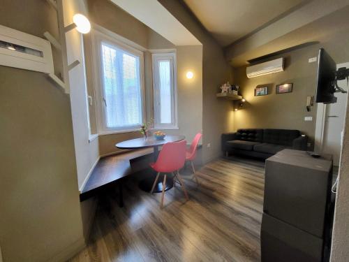 a small living room with a table and chairs at Primo Passo The Lorax in Arco
