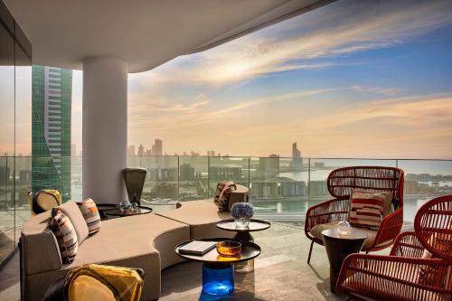 a living room with a view of the city at Conrad Bahrain Financial Harbour in Manama