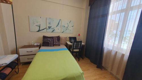 a bedroom with a bed and a desk and a window at Feeling at home in İstanbul Center 5 Minutes walk to The Ataköy Metro Station & Metrobus in Istanbul